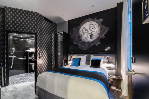a bedroom with a large bed and a bathroom at Hotel Splendor Elysées in Paris