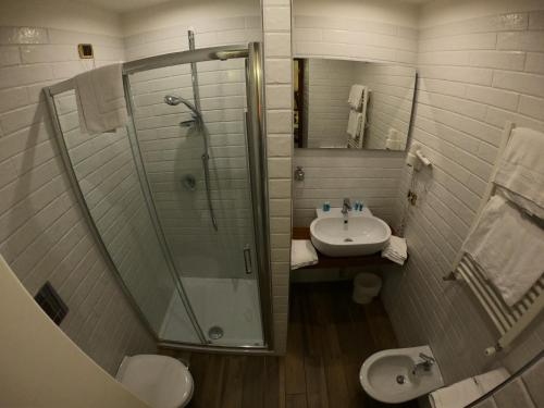 a bathroom with a shower and a sink at Hotel Ausonia in Naples
