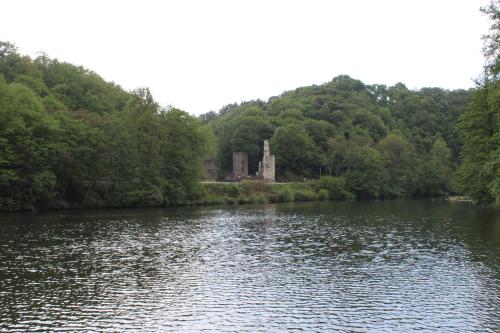 a body of water with a castle in the distance at Grüner Blick in Witten