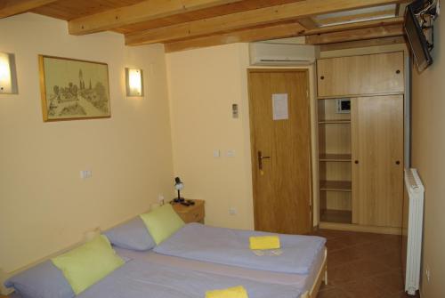 a small bedroom with a bed and a wooden door at Apartments & Rooms BARBARA in Umag