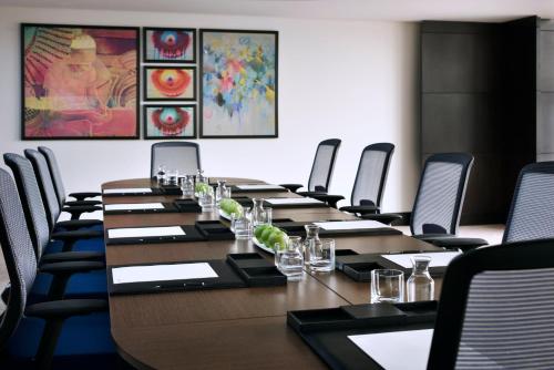 a conference room with a long table and chairs at Voco - Riyadh by IHG in Riyadh