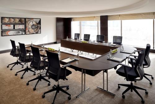 a conference room with a large table and chairs at Voco - Riyadh by IHG in Riyadh