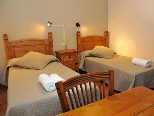 a room with two beds and a table and a table sidx sidx sidx at Casa Rural LA FUENTONA in Valle de Tabladillo