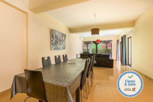 a dining room with a long table and chairs at Marina de Albufeira Villa 8 in Albufeira