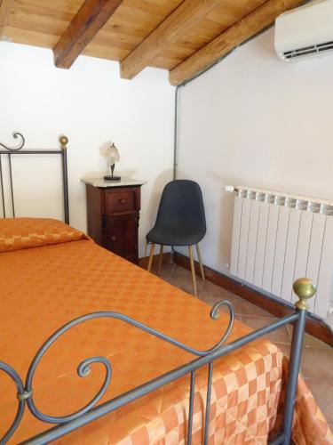 a bedroom with a bed and a chair at B&B Villa San Marco in Agrigento