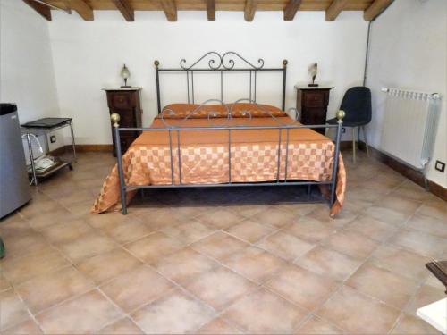 a bedroom with a bed and two tables and a chair at B&B Villa San Marco in Agrigento
