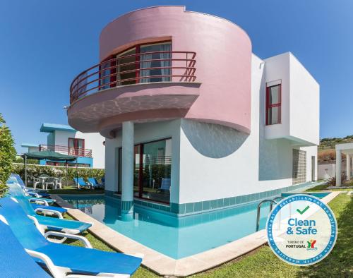a villa with a swimming pool and a round house at Marina de Albufeira Villa 8 in Albufeira