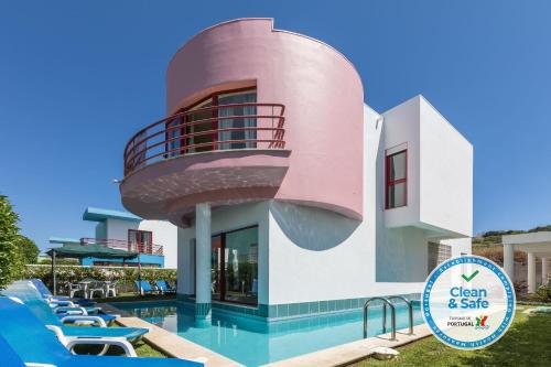 a villa with a swimming pool and a round house at Marina de Albufeira Villa 8 in Albufeira