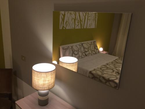 a reflection of a bedroom with a bed in a mirror at B&B Hollywood in Olivadi
