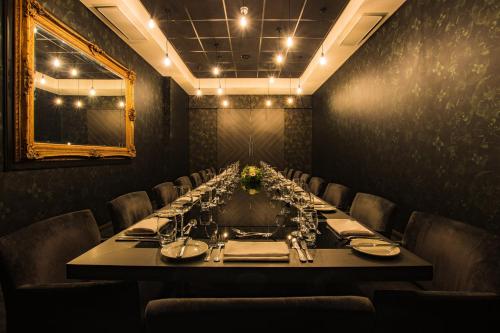 a dining room with a long table and chairs at Crowne Plaza Birmingham City by IHG in Birmingham