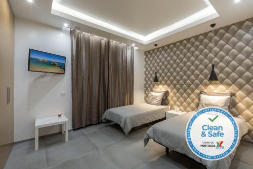 a bedroom with two beds and a sign for clean and sale at Luxury 47 in Albufeira
