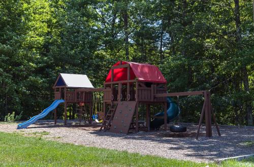 a playground with a slide and a slideintend at Fox Ridge Resort in North Conway