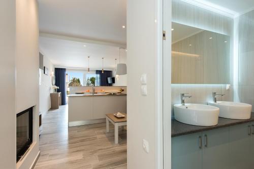 a bathroom with two sinks and a living room at Anita Village in Perama