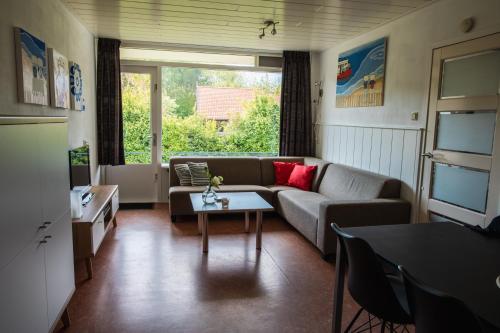 a living room with a couch and a table at Vakantiehuisje Martina 24 in Vlissingen