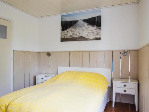 a bedroom with a bed and two night stands at Vakantiehuisje Martina 24 in Vlissingen
