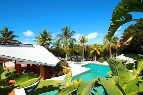 a resort with a swimming pool and palm trees at Bahia Bay Resort in Key Largo