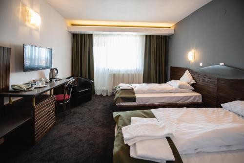 Postel nebo postele na pokoji v ubytování Hotel Park Sfantu Gheorghe