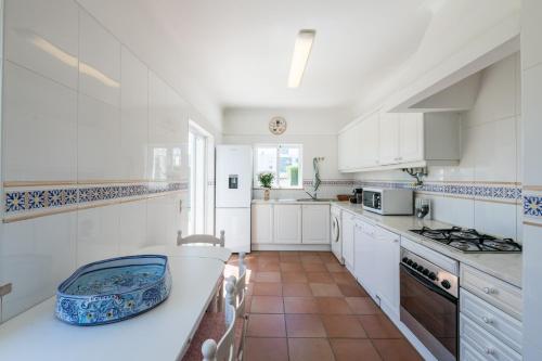 a kitchen with white cabinets and a white counter top at Villa near the beach and Lagos Marina #1868 in Lagos