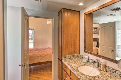 a bathroom with a sink and a mirror and a bed at Luxe Scottsdale Home with Horse Stables and Pool! in Scottsdale