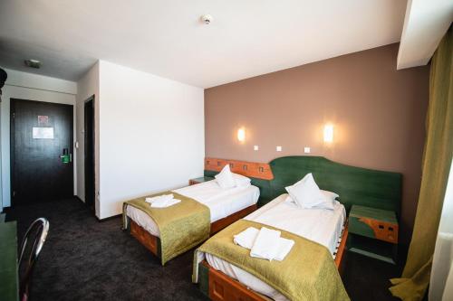 Postel nebo postele na pokoji v ubytování Hotel Park Sfantu Gheorghe