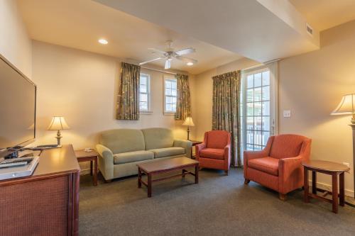 a living room with a couch and two chairs at Ebb Tide Suites in Ocean City