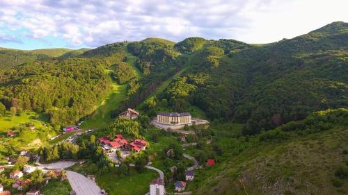an aerial view of a house in the middle of a mountain at Apartment Invictus Mavrovo in Mavrovo