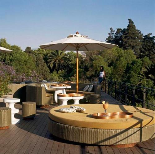 un patio con una mesa y una sombrilla en Condesa df, Mexico City, a Member of Design Hotels, en Ciudad de México