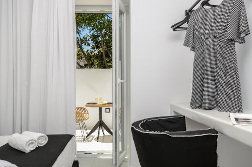 a bathroom with a sink and a chair next to a mirror at Diadema Apartments in the Town in Naxos Chora