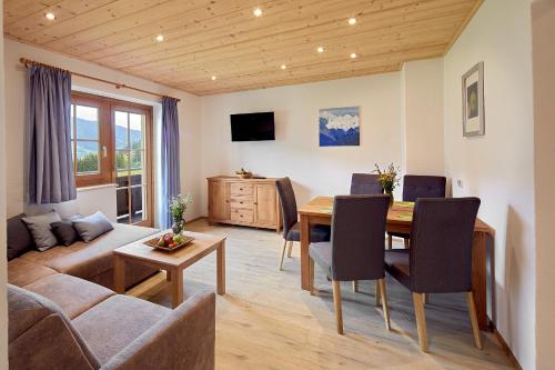 a living room with a table and a couch at Vordergugg in Mittersill