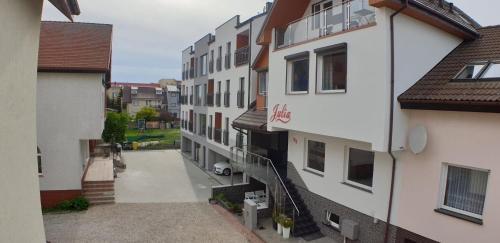 an apartment building with a walkway between two buildings at Apartamenty Julia APARTAMENTY OZONOWANE in Ustronie Morskie