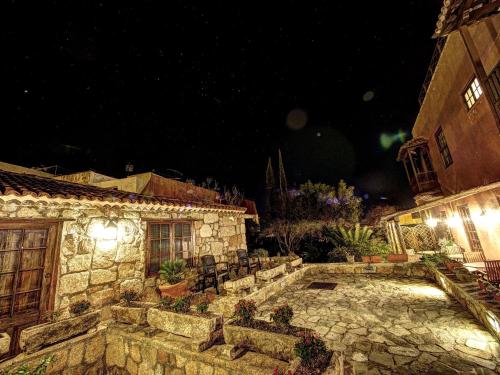 a stone building with a patio at night at Hotel Rural San Miguel - Only Adults in San Miguel de Abona