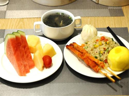 a table with two plates of food and a cup of coffee at KyriadChina Changsha the zone of environment protection hotel in Changsha
