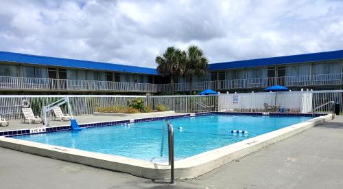 a large swimming pool in front of a hotel at Days Inn by Wyndham Titusville Kennedy Space Center in Titusville