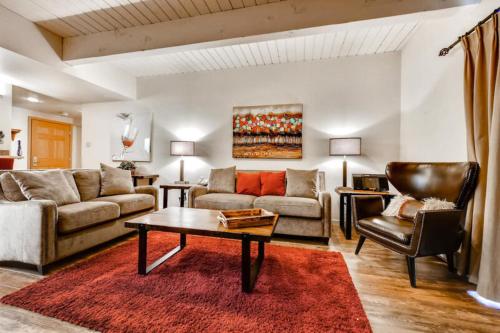 a living room with a couch and a table at Ptarmigan House in Steamboat Springs
