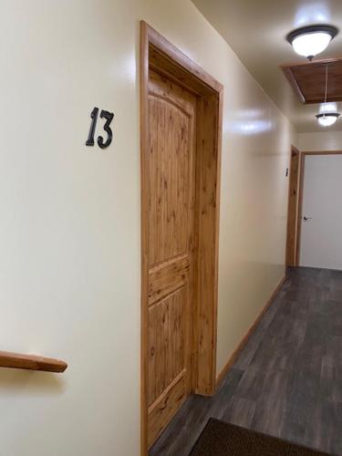 a room with a wooden door with a number on the wall at Yellowstone Riverside Cottages in Gardiner