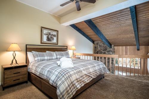 a bedroom with a large bed and a balcony at Ptarmigan House in Steamboat Springs