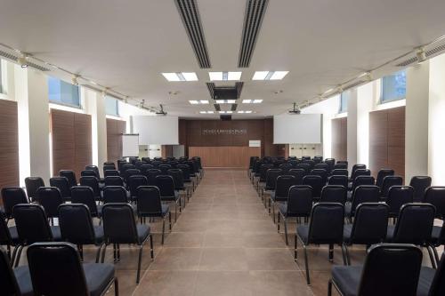 a room with rows of chairs in a hall at Best Western Plus Hotel Monza e Brianza Palace in Cinisello Balsamo