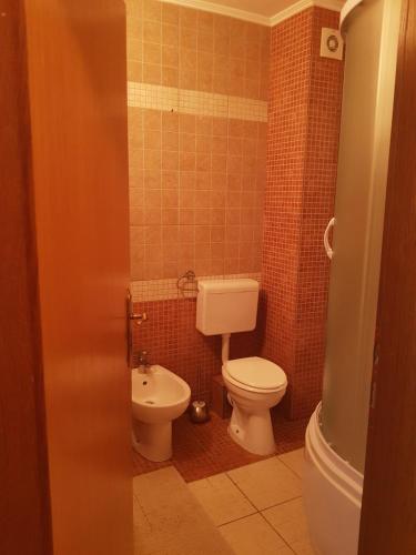a bathroom with a toilet and a sink at Vlasicka avantura Eko Fis 509 in Vlasic