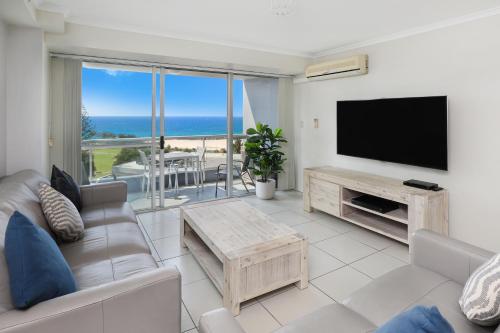 a living room filled with furniture and a tv at Points North Apartments in Gold Coast