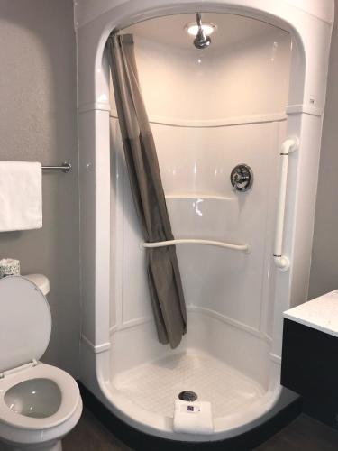a small bathroom with a shower with a toilet at Motel 6-Fort Wayne, IN in Fort Wayne