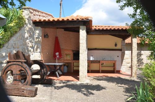 a patio of a house with a table in it at Casa das Vessadas in Celorico de Basto