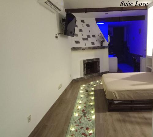 a bedroom with a bed with lights on the floor at Suite Love Jacuzzi (Casas Toya) in Uceda