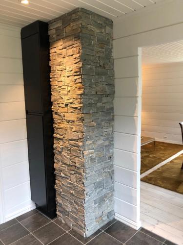 a stone wall in the corner of a house at Tunold Gård - Freden in Stryn
