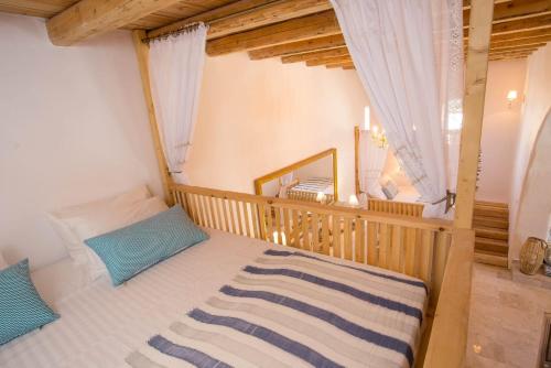 a bedroom with a bed with a wooden crib at White Rose in Kalithies