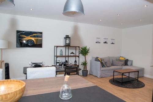 a living room with a couch and a table at Cocoon in East-Brussels in Wezembeek-Oppem