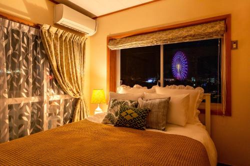 a bedroom with a bed and a window with a view at New open American Village Sunset beach TLA&TDY mihama the first in Okinawa City