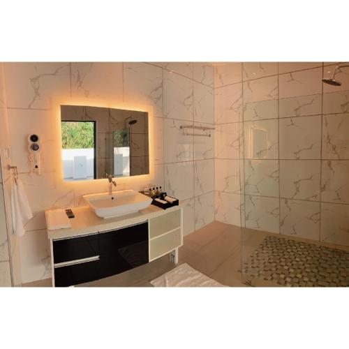 a bathroom with a sink and a mirror at Marina Point Bay Resort in Panglao Island
