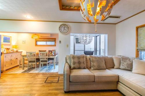 a living room with a couch and a dining room at New open American Village Sunset beach TLA&TDY mihama the first in Okinawa City