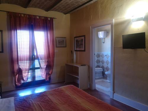 Ένα ή περισσότερα κρεβάτια σε δωμάτιο στο Agriturismo Olimpo