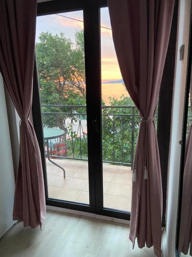 a sliding glass door with a view of a balcony at Rooms Milena in Senj